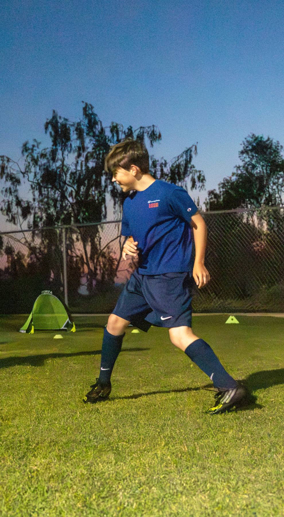 Coach Luka and a player grinning through a passing drill at dusk, the Signature Cycle at The Soccer Lab, Carlsbad